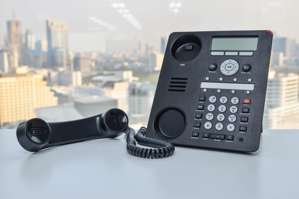 Hold time is not just a gap in service, it’s a chance to deliver value. - Office phone with handheld receiver off to convey a call on hold