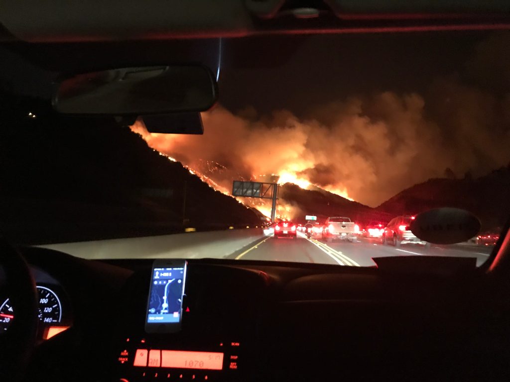Inside a car on a highway fleeing a wildfire surrounded by smoke - Why U.S. Businesses Need Regionally Relevant Messaging